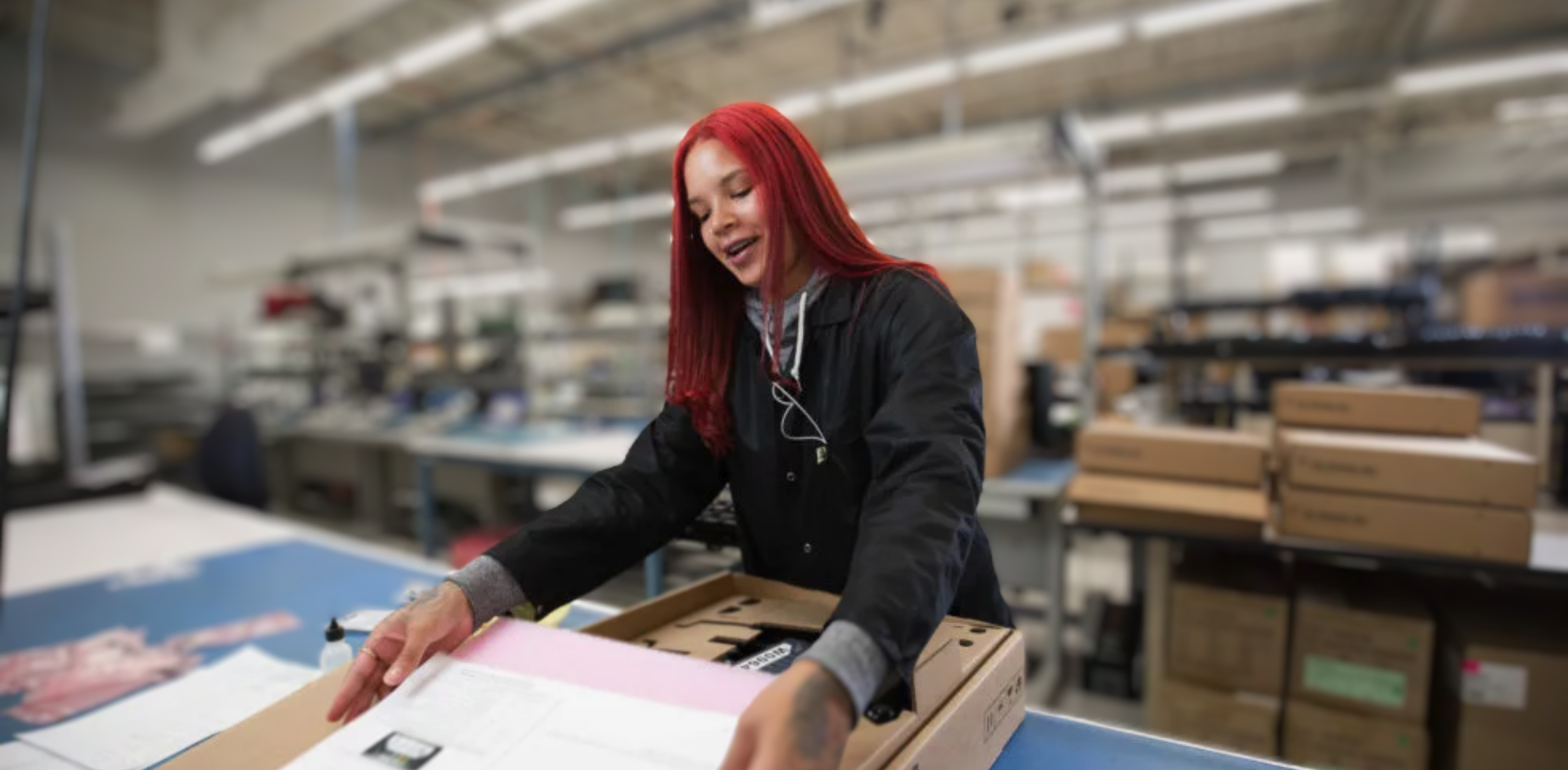Technician looking at design specs in factory
